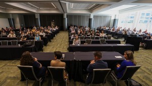 An indoor image of KBHN Deputy Science Officer Jennifer Zwicker and other panelists presenting to a full audience at the Vancouver Convention Centre.