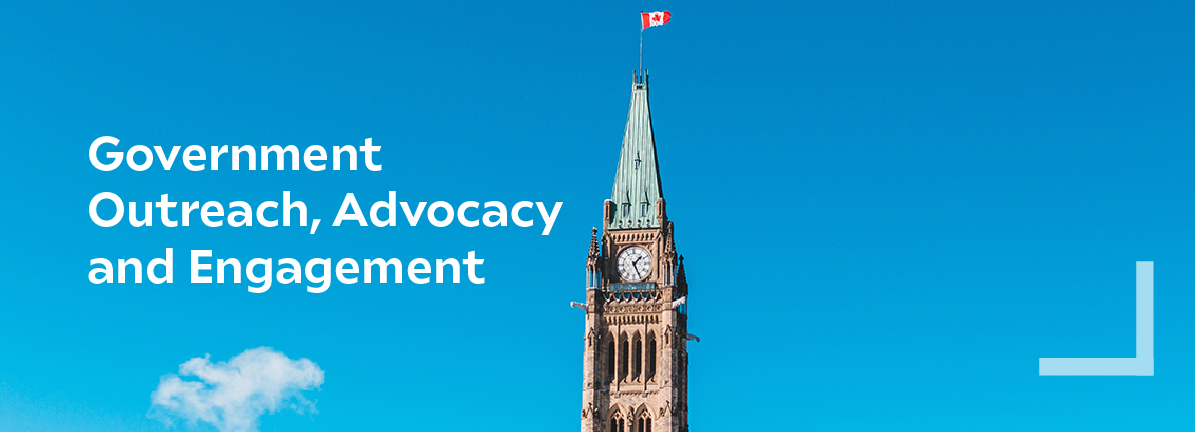 A photo of the Parliament Buildings with the Canadian flag on top and the sky as the background
