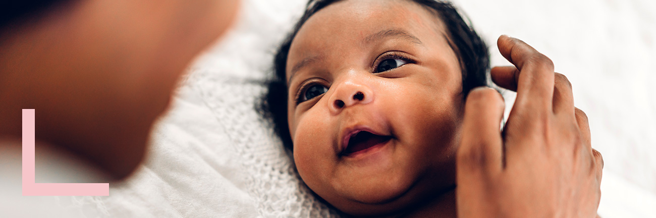 Smiling mother carrying her child